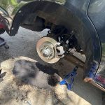 Mobile mechanic replacing rear brake rotor and caliper on an SUV in Sheboygan County, Wisconsin.