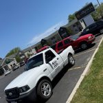 Midwest Mobile Mechanic 920 service truck parked beside a red Chevrolet Blazer at a customer repair location.