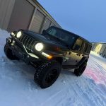 Black Jeep Wrangler serviced by a mobile mechanic in Sheboygan County, Wisconsin during winter conditions.